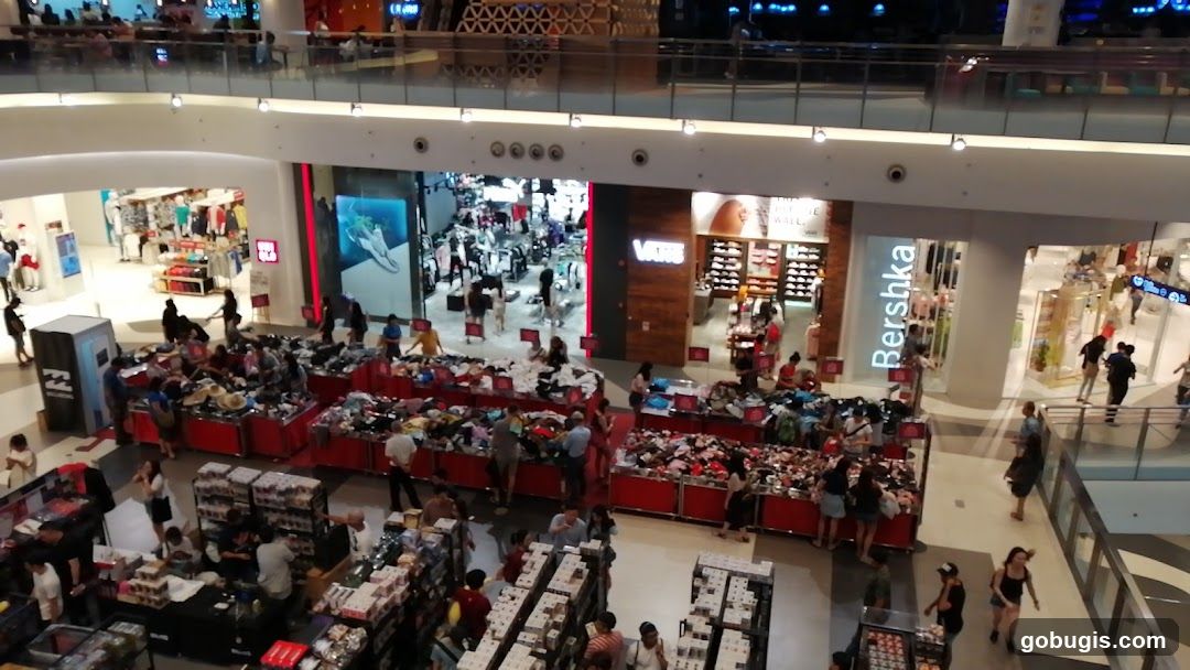 Busy shopping mall with sale displays