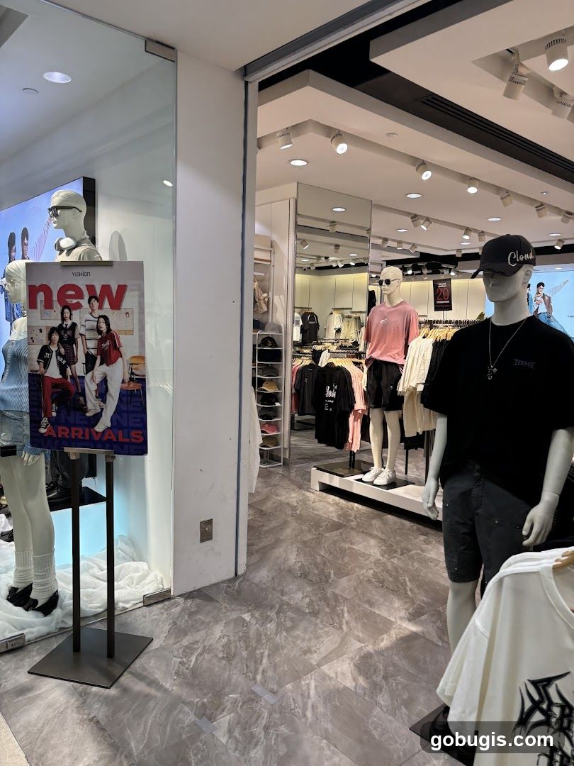 Clothing store interior with mannequins and new arrivals display