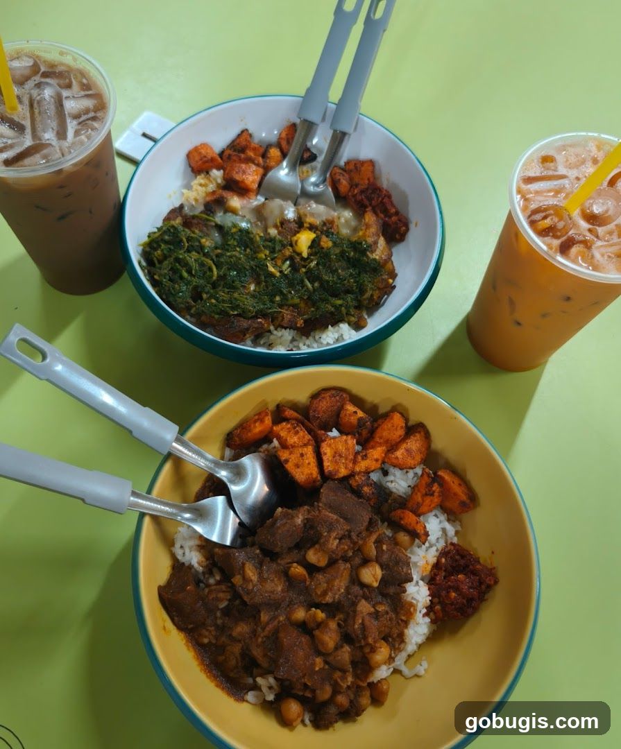 Two bowls of rice with toppings and two iced drinks