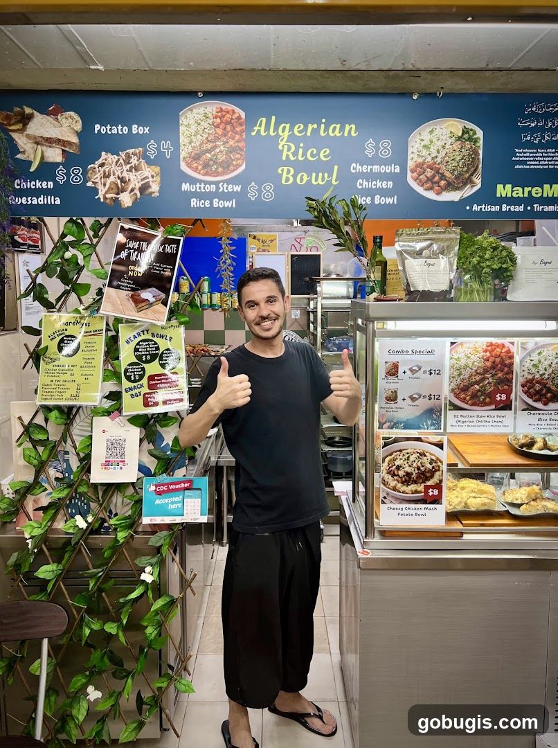Man Posing in Front of Food Stall