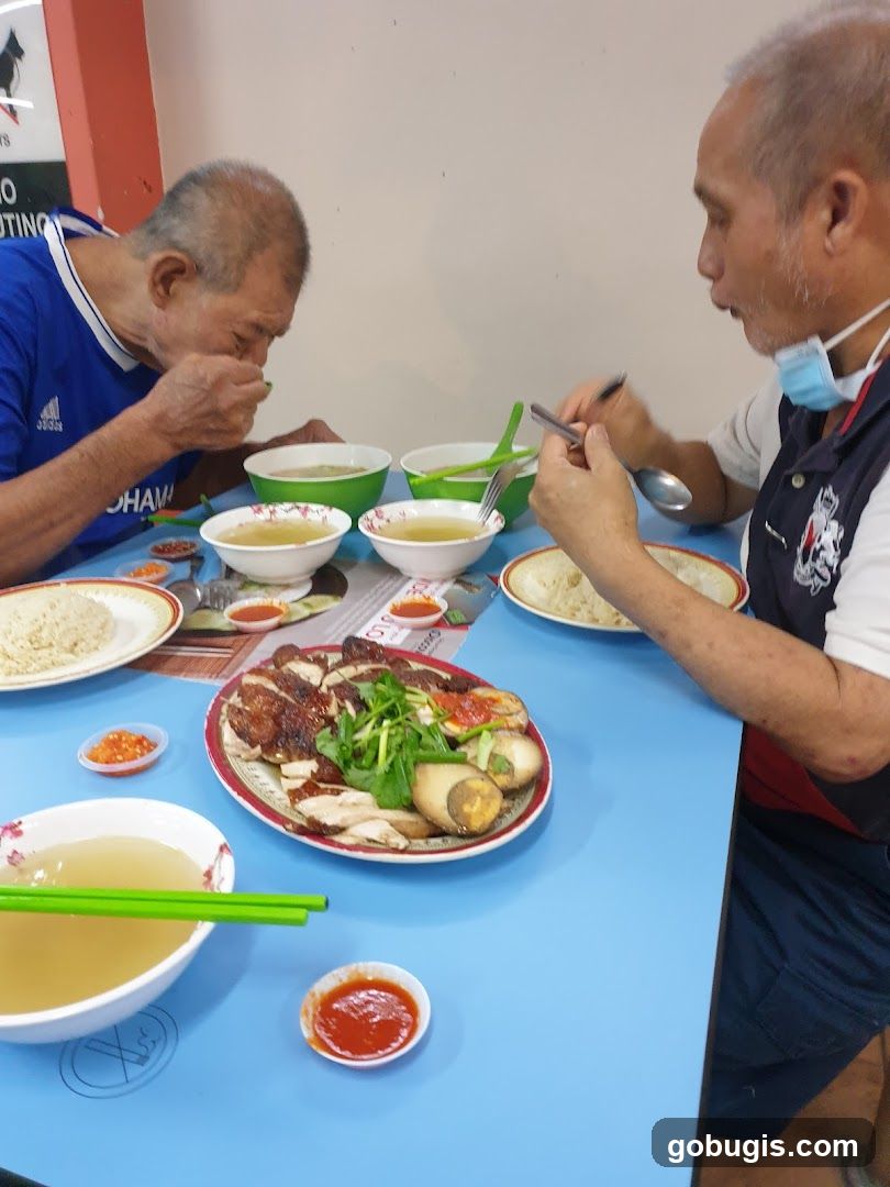 Two Men Eating Chicken Rice