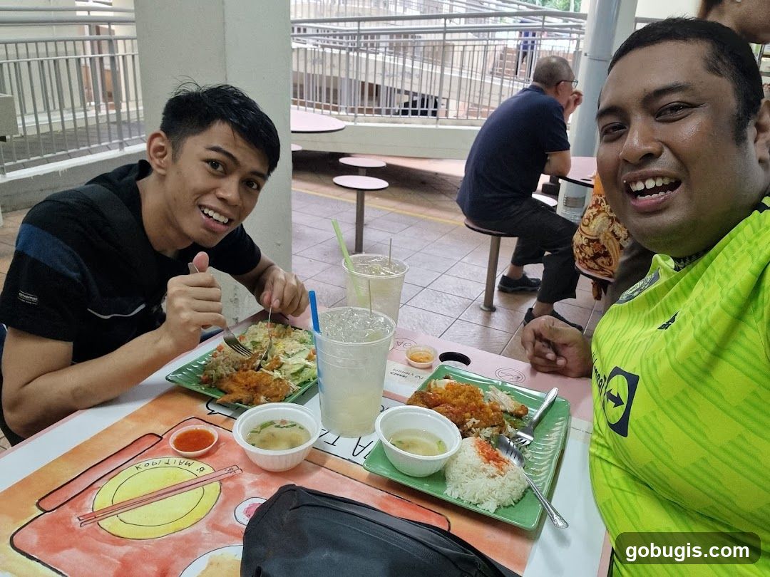 Two men enjoying a meal at a food court