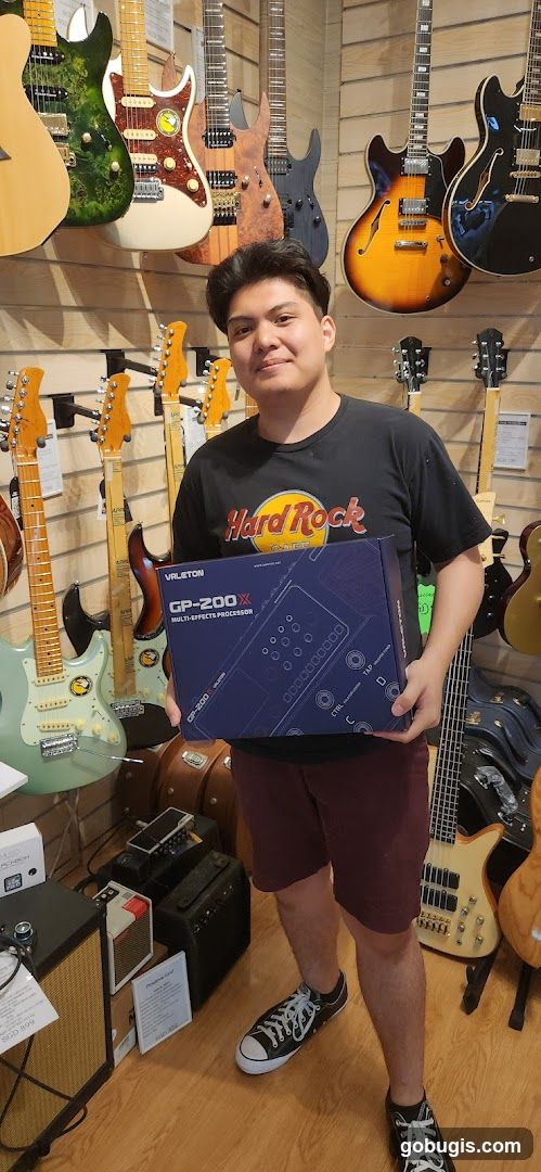 Man Holding Guitar Effects Pedal Box
