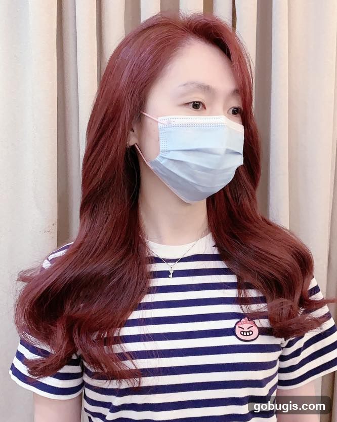 Woman with Red Hair Wearing a Mask
