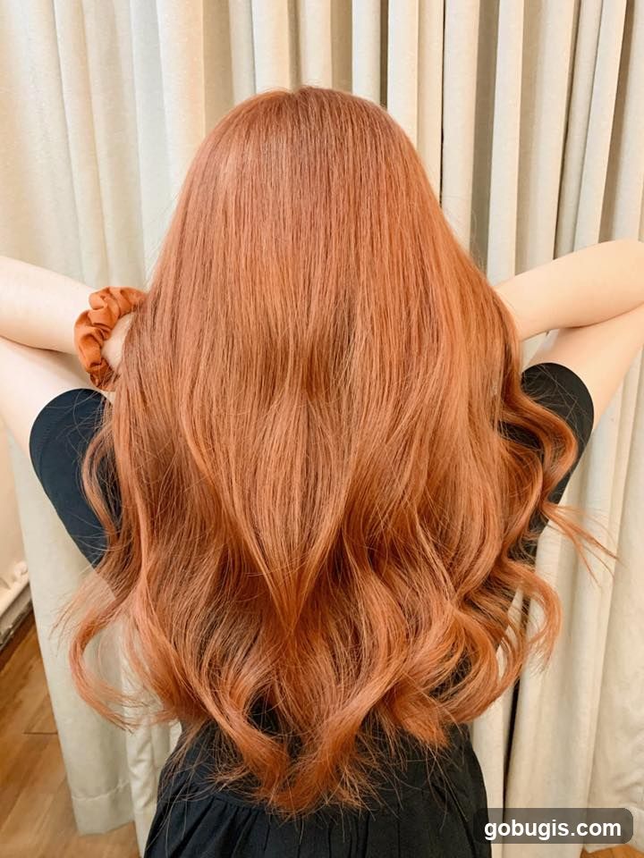 Woman with long, wavy, copper-colored hair