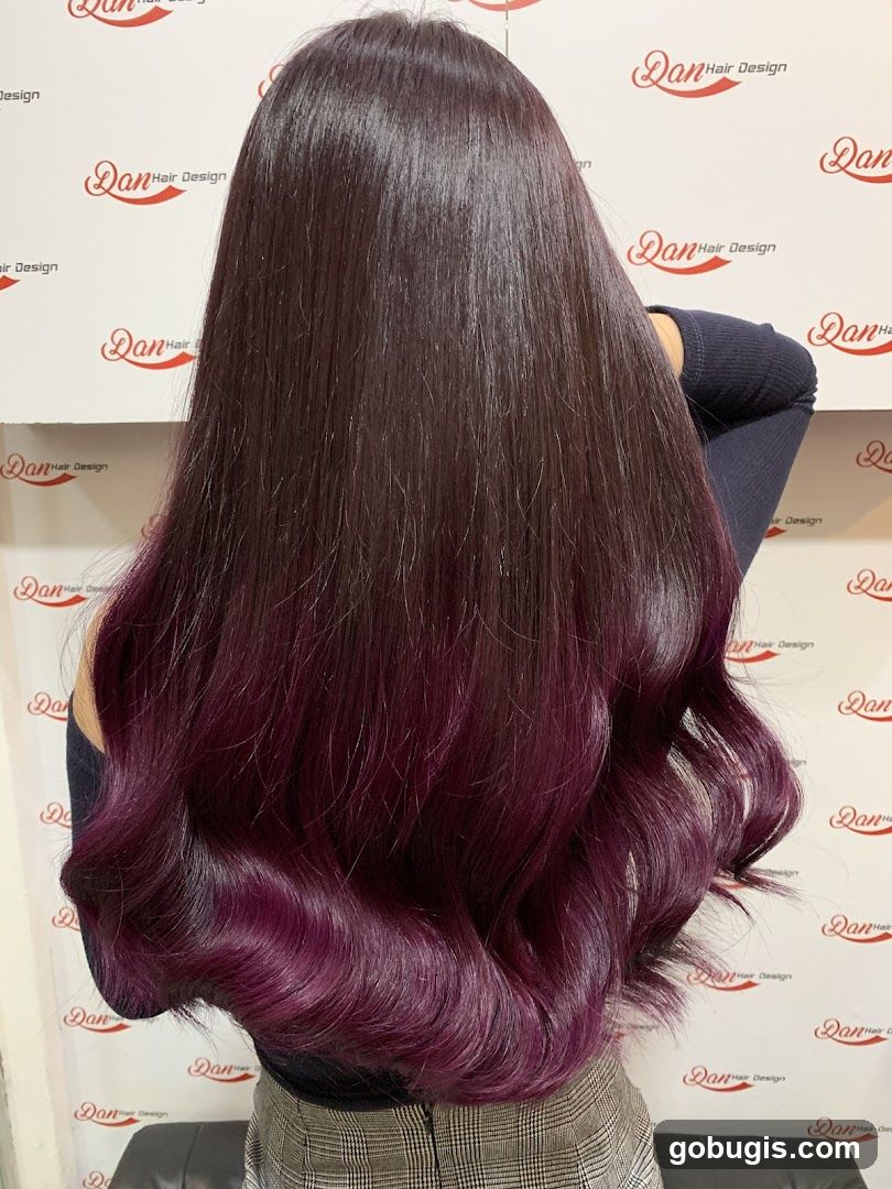 Woman with long, dark hair with purple ombre