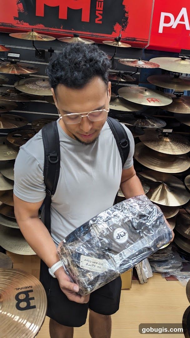Man holding drum hardware