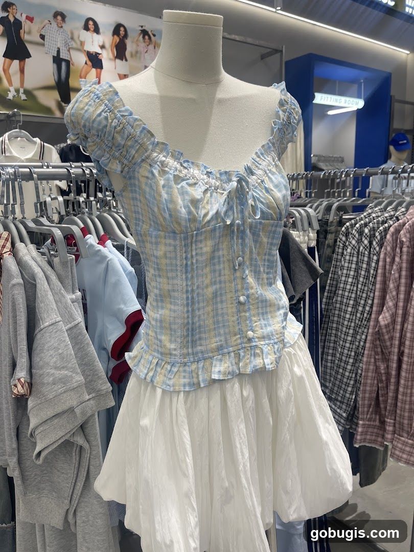 Mannequin wearing a blue and yellow plaid corset top with a white skirt
