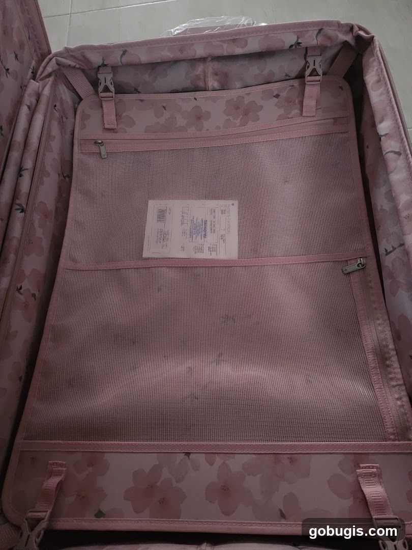 Open pink suitcase with floral pattern