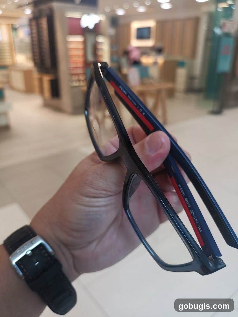 Person holding glasses in a store