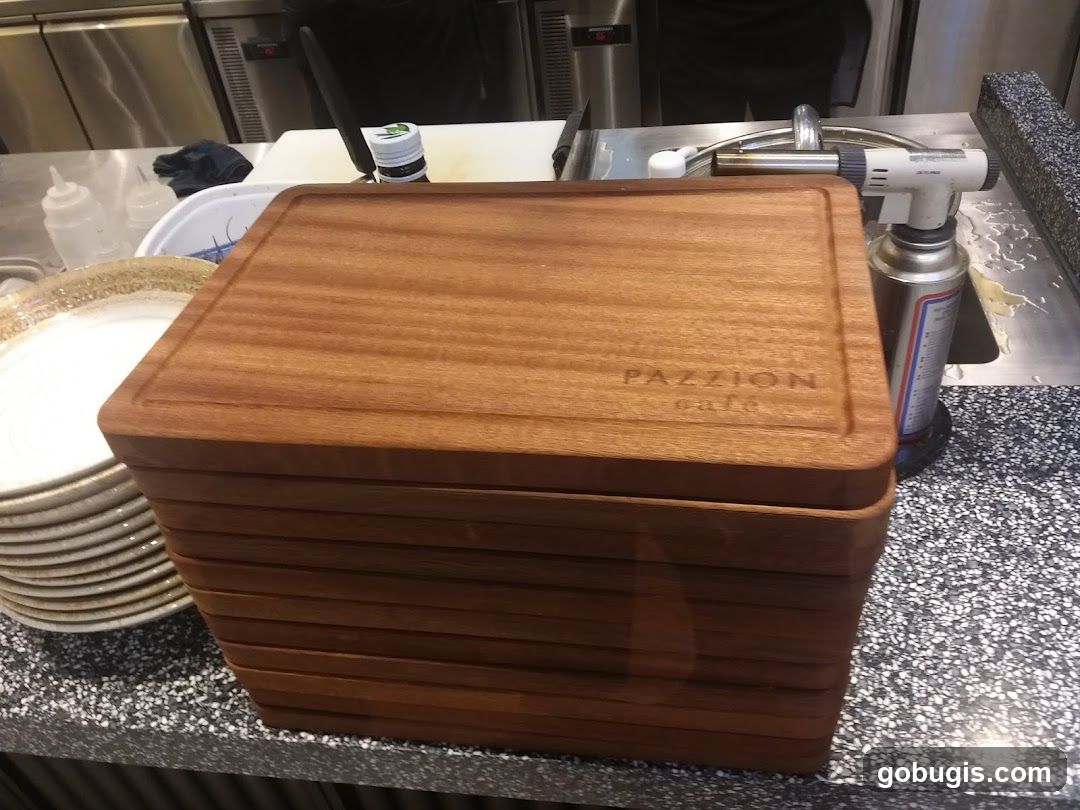 Stack of wooden cutting boards with cafe logo