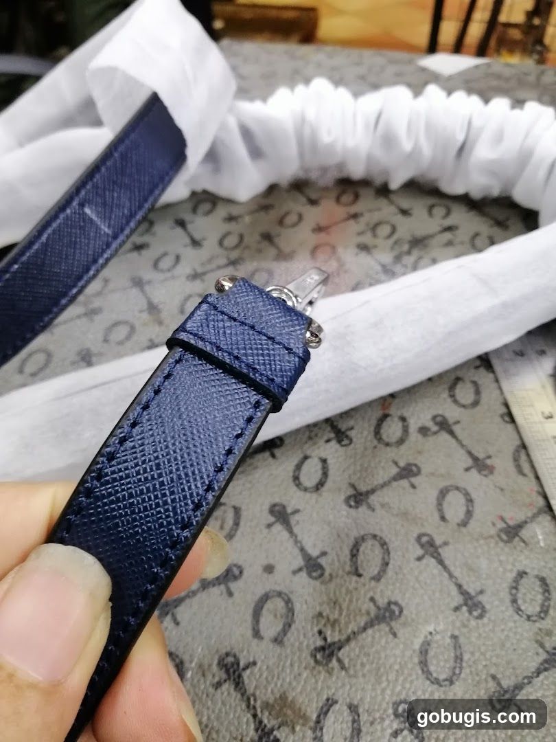 Close-up of a dark blue strap with metal hardware.