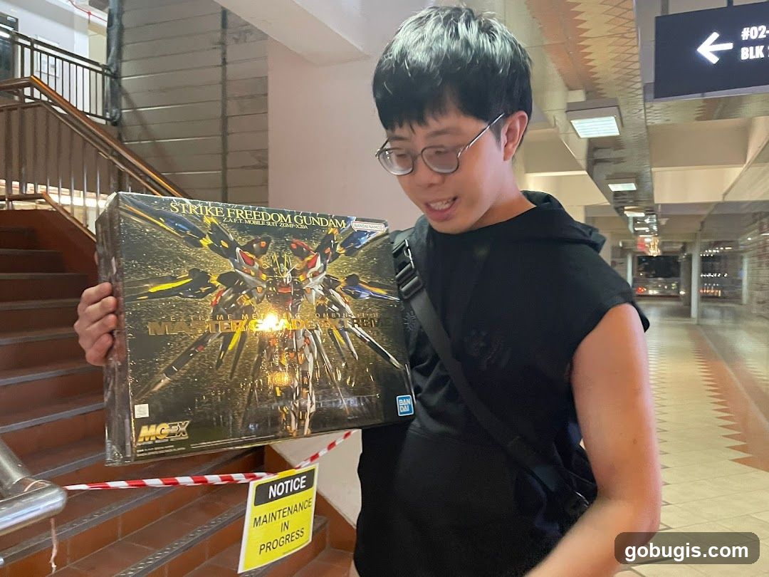 Man holding a Gundam model box