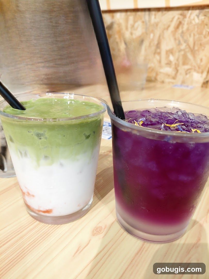 Two colorful drinks on a wooden table