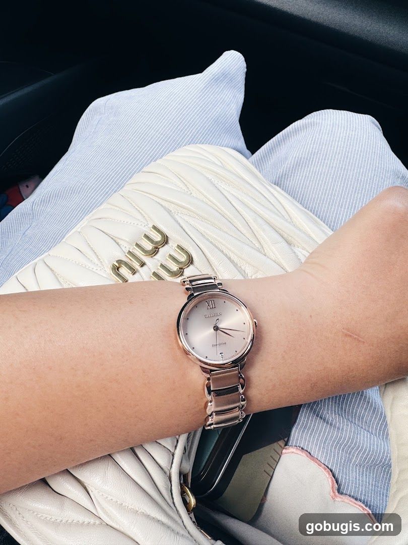 Woman wearing a rose gold Citizen Eco-Drive watch