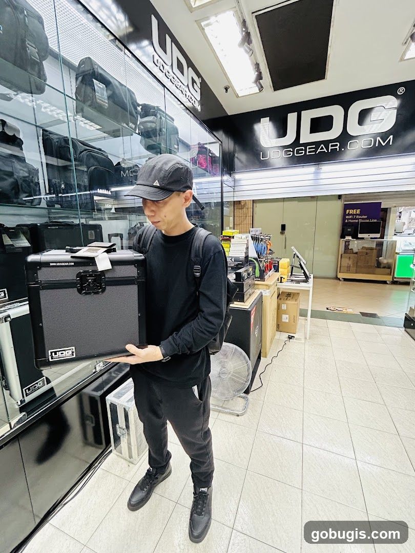 Man holding a black case in a store