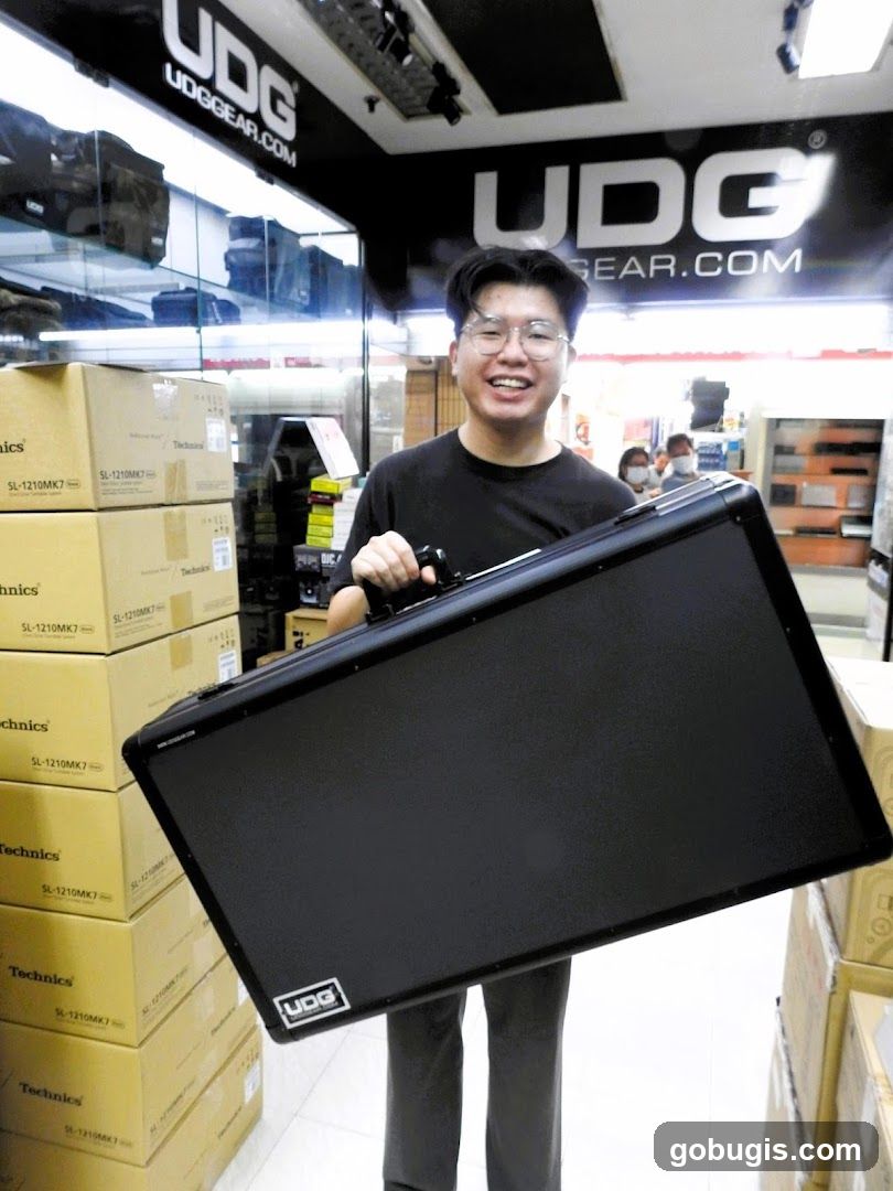 Man holding a black case in a store