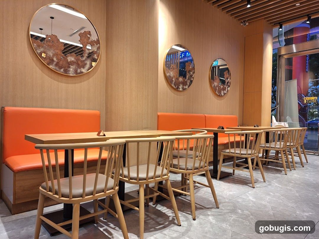 Restaurant Interior with Orange Booths and Wooden Chairs