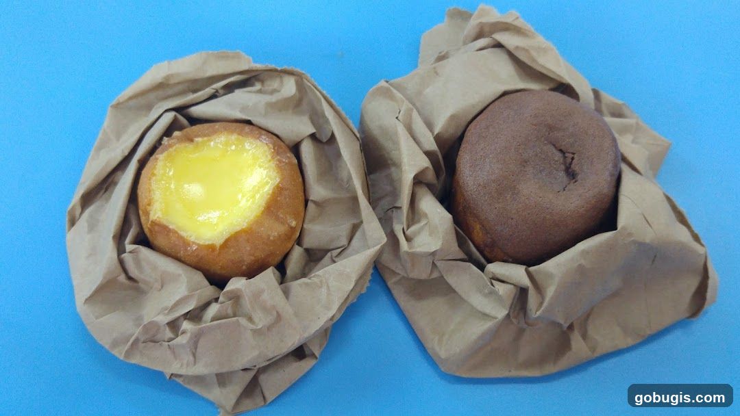 Two pastries in paper bags