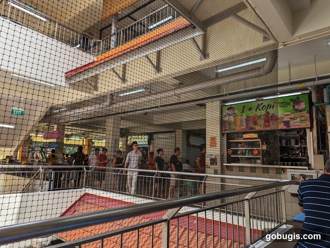 Food court interior with people queuing