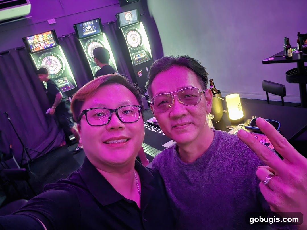 Two men posing for a selfie in a dart bar