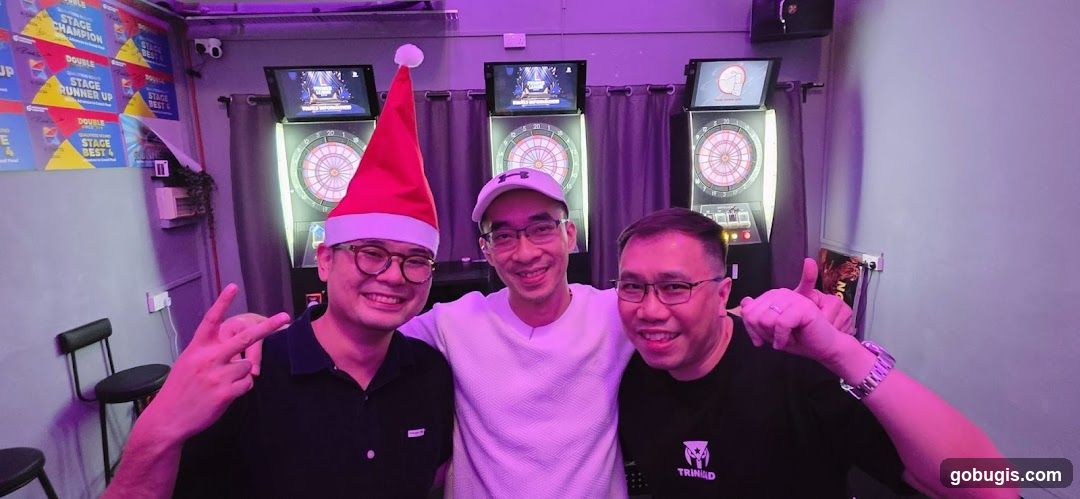 Three men posing in a dart lounge