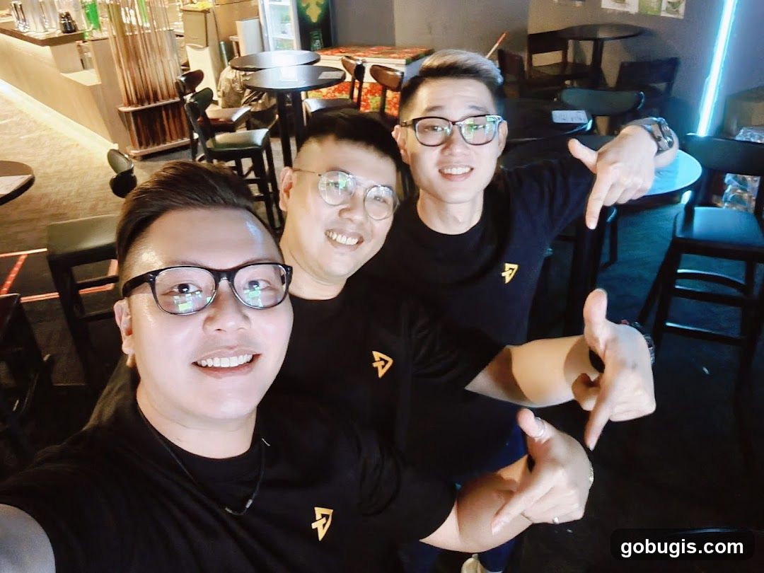 Three men posing for a photo in a bar