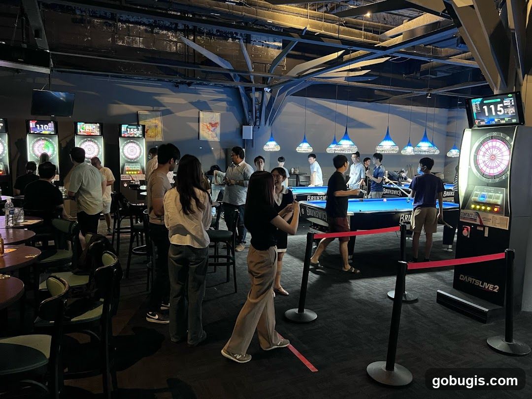 People playing darts and billiards