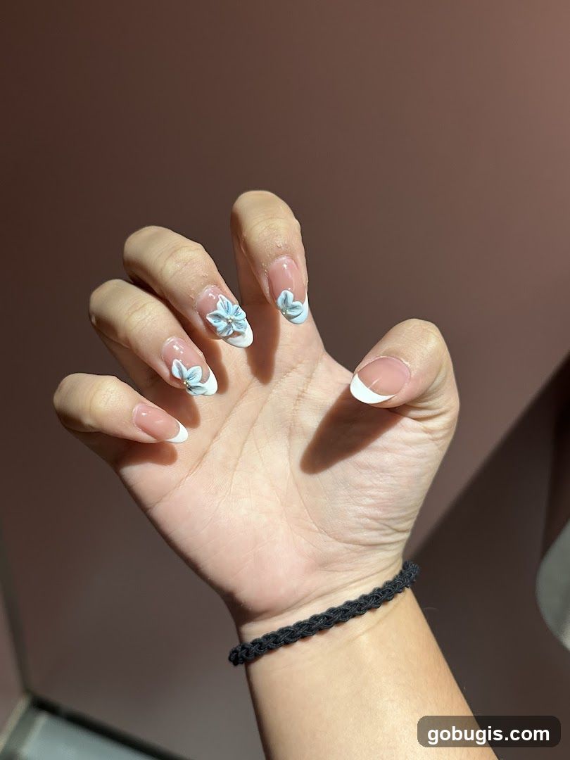 French Manicure with 3D Floral Accents