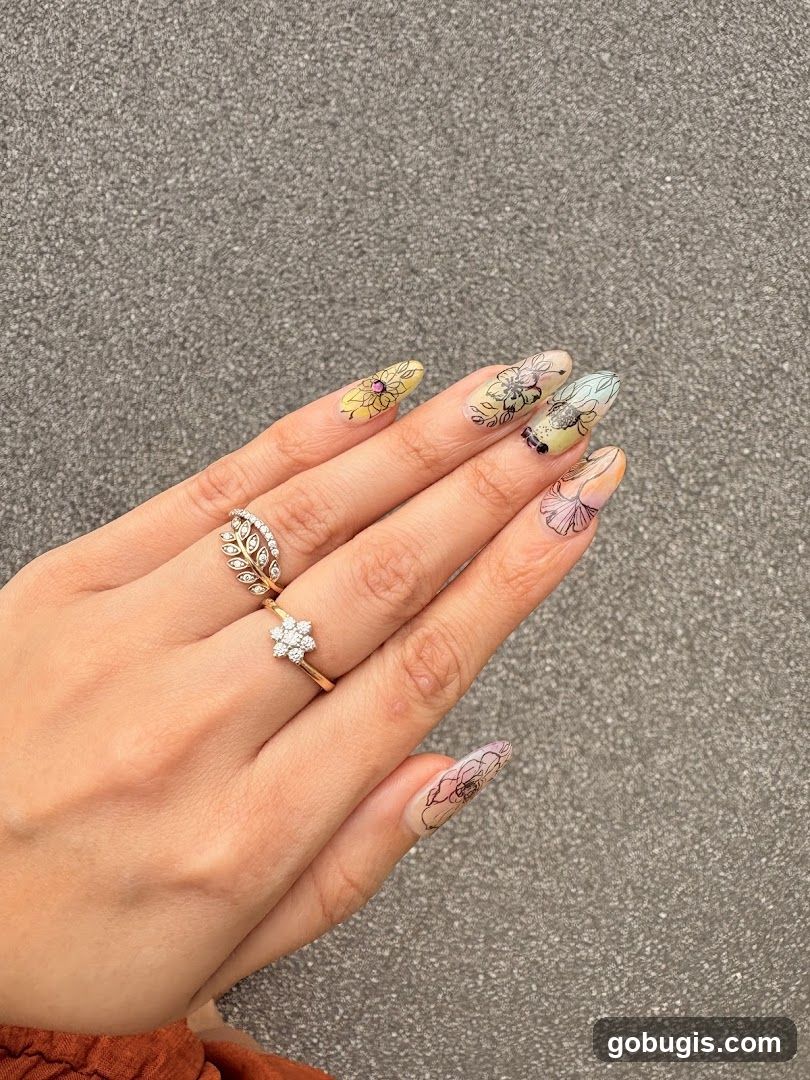 Hand with floral nail art and rings