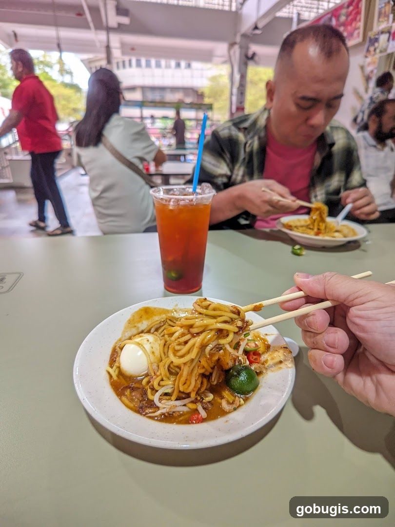 People eating noodles at a food court