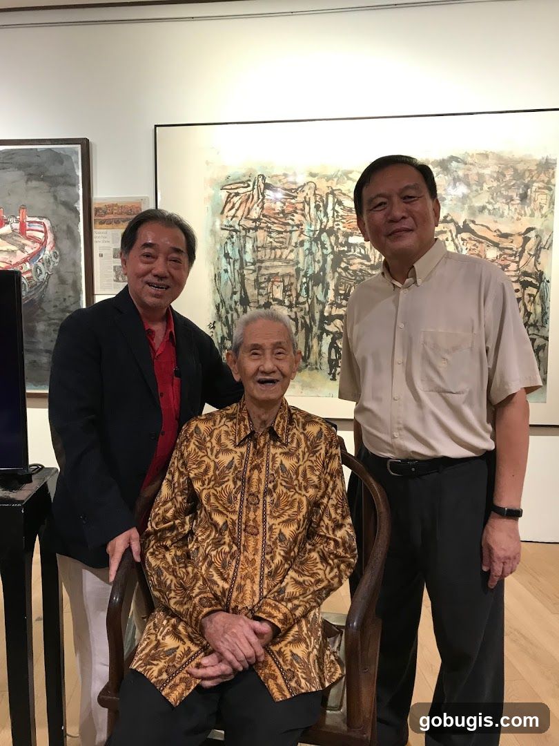 Three men posing in front of artwork