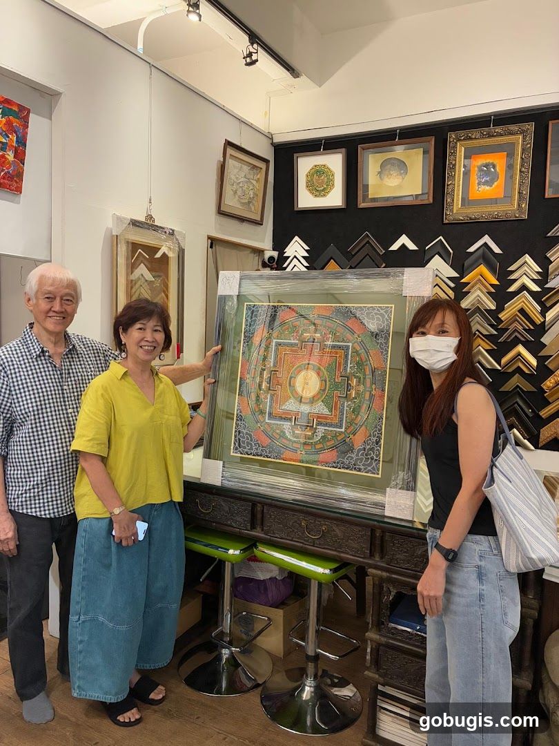People admiring a framed artwork