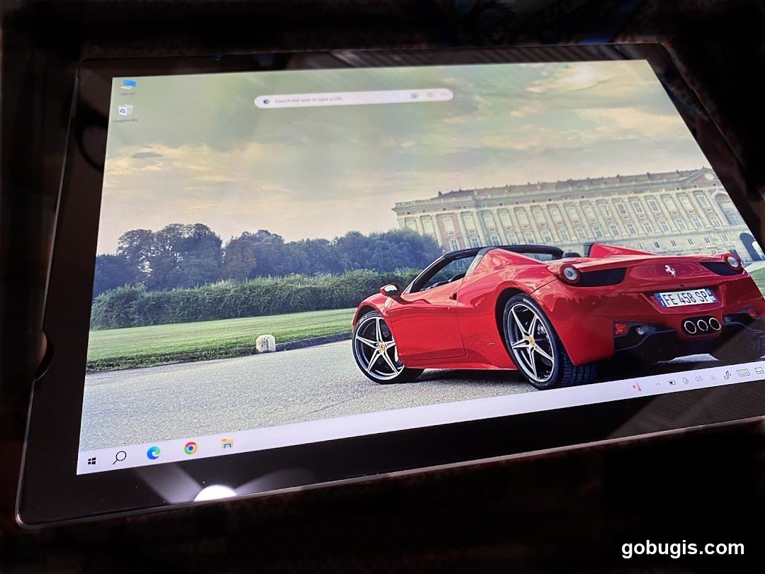 Tablet displaying a red convertible sports car