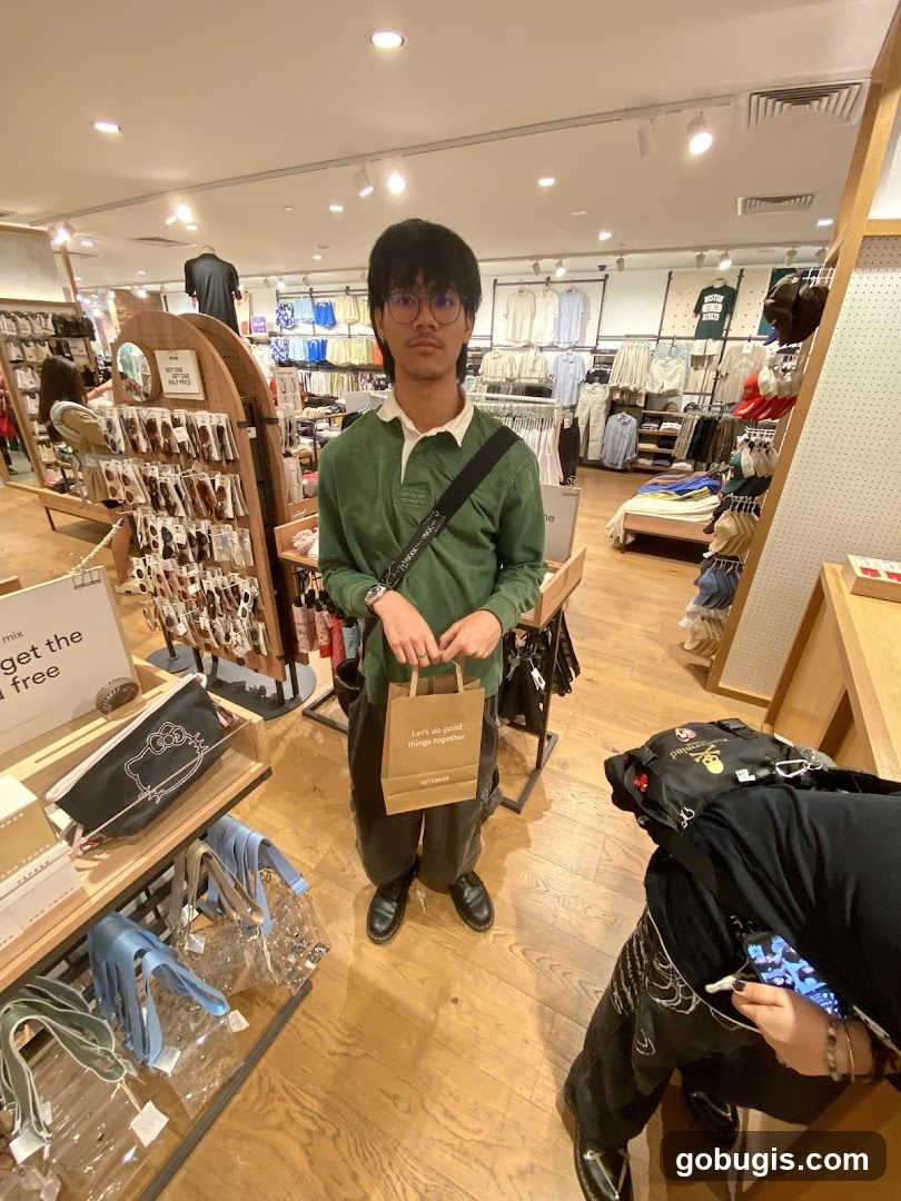 Person holding a shopping bag in a store
