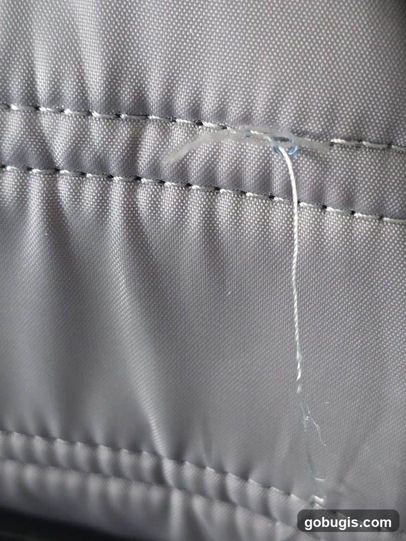 Close-up of stitching on gray fabric