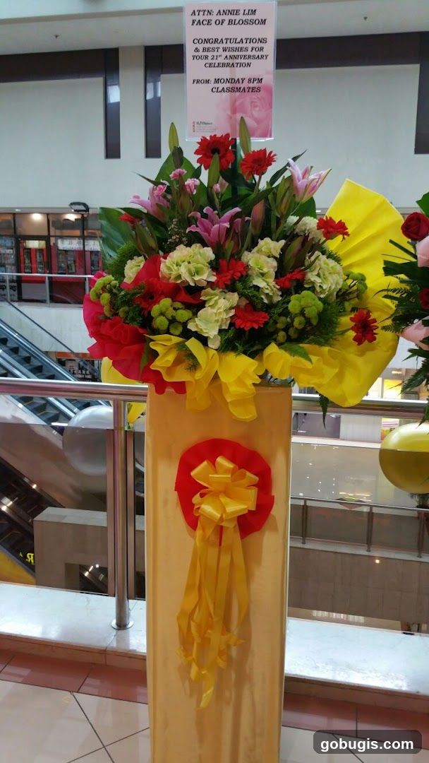 Flower arrangement with congratulatory sign