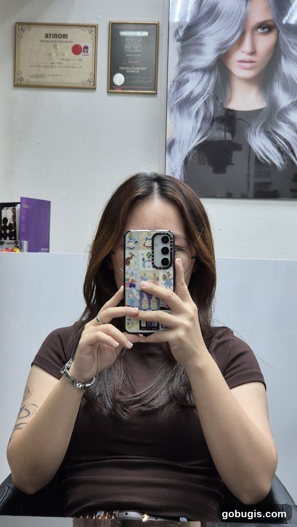 Woman taking a selfie in a salon