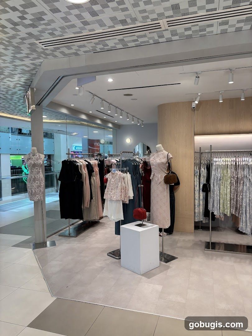 Clothing store interior with mannequins and racks of dresses