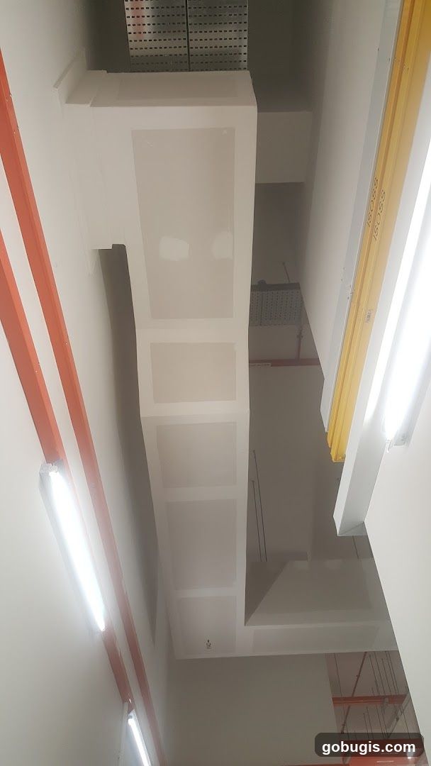 Interior view of a building with exposed ductwork and lighting