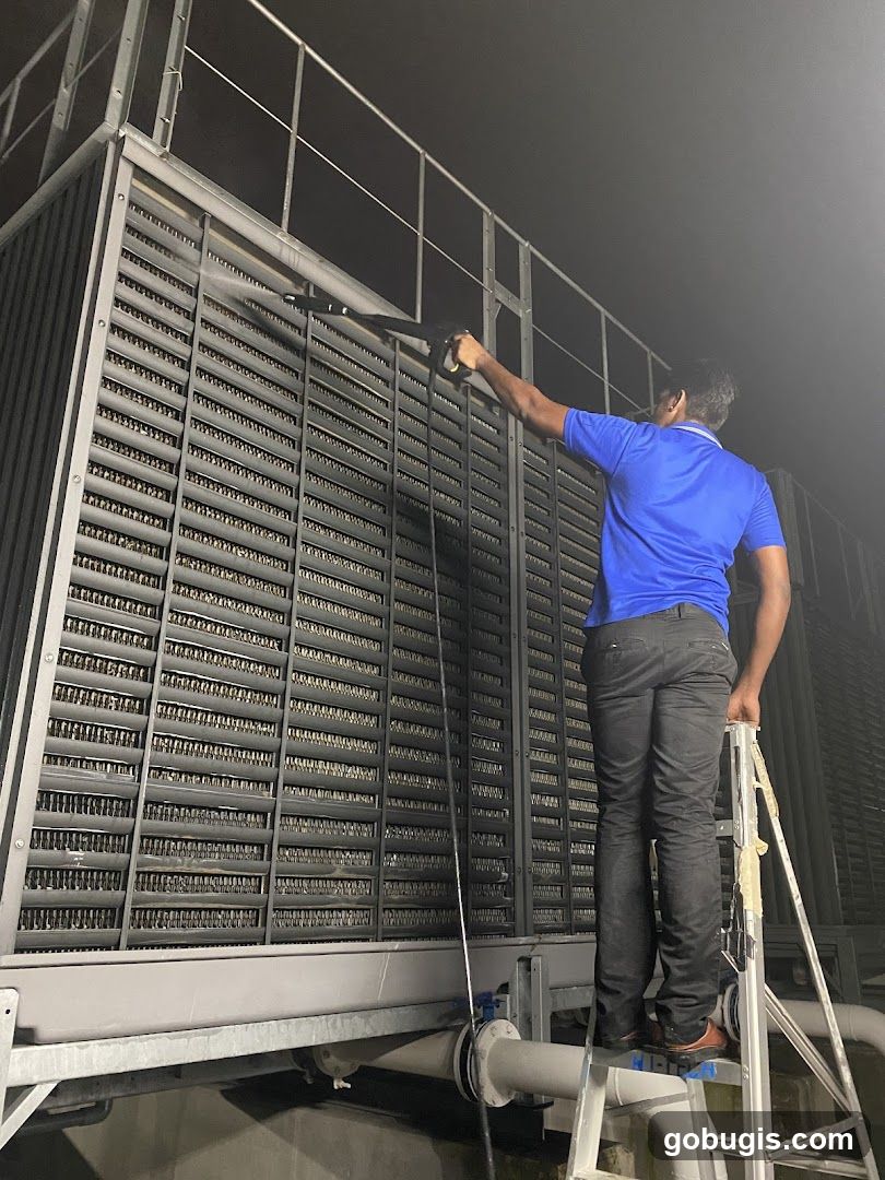 Worker cleaning a cooling tower
