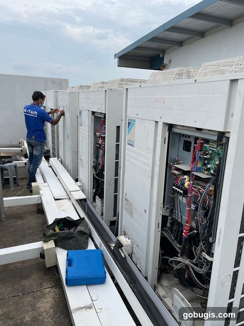 Technician working on air conditioning units