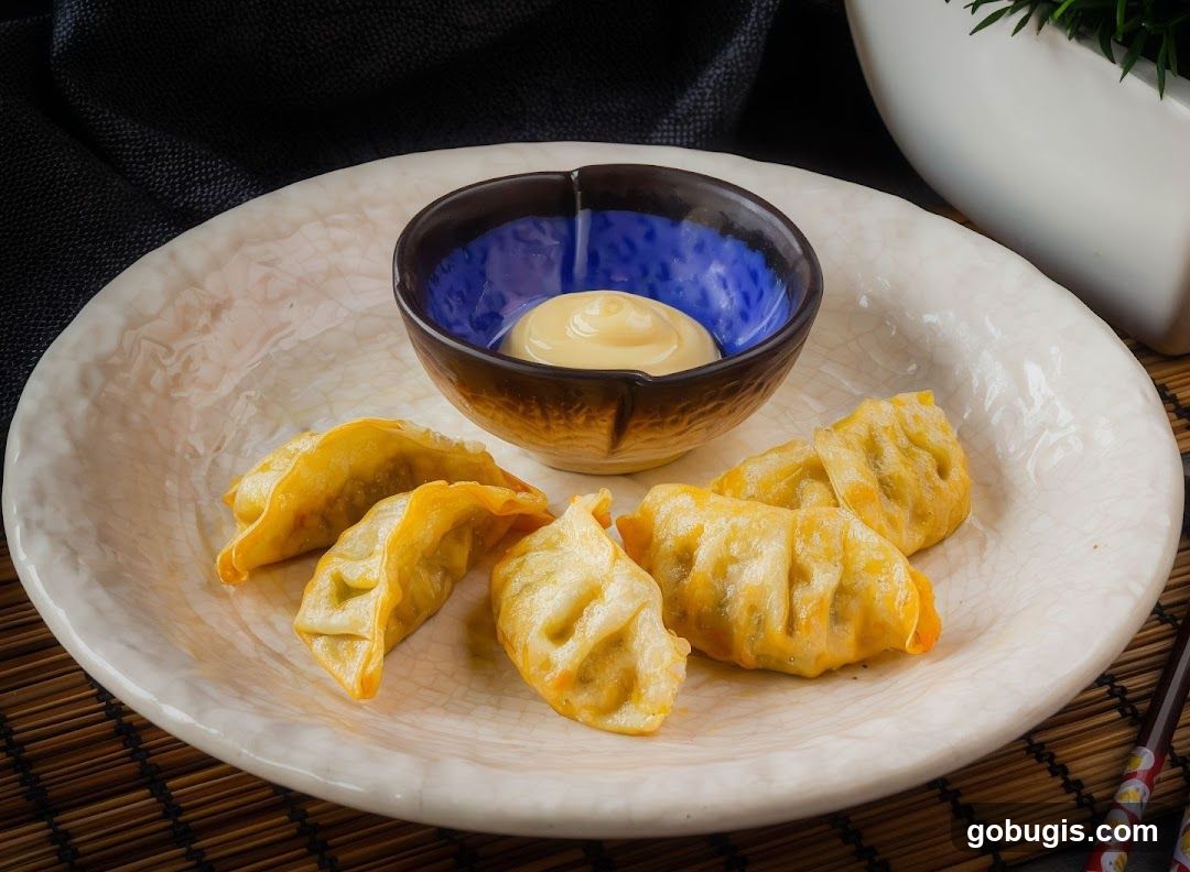 Pan-fried dumplings with dipping sauce