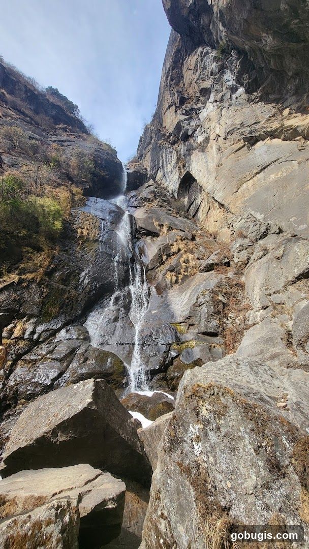 Waterfall cascading down rocky cliff