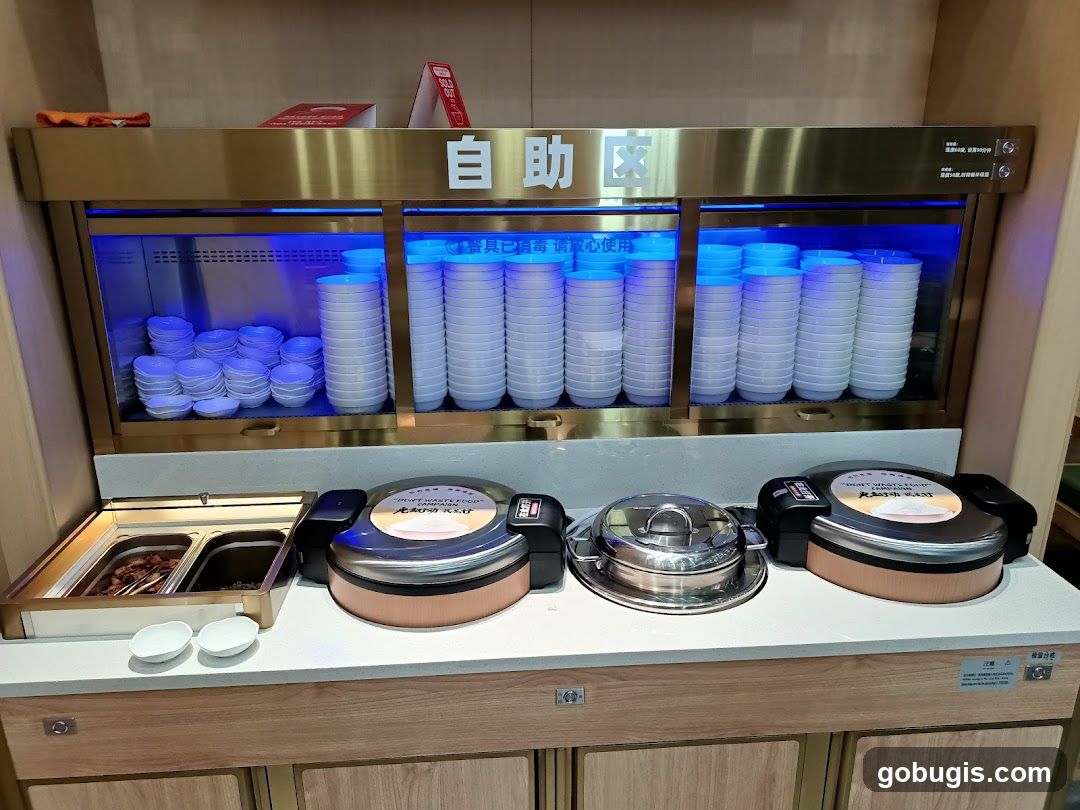Buffet Station with Stacks of Bowls and Food Warmers