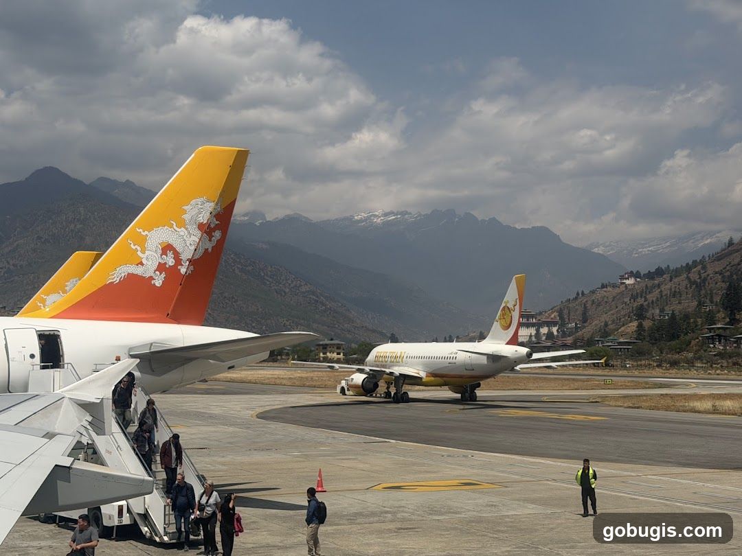 Airport Tarmac with Airplanes and Mountains