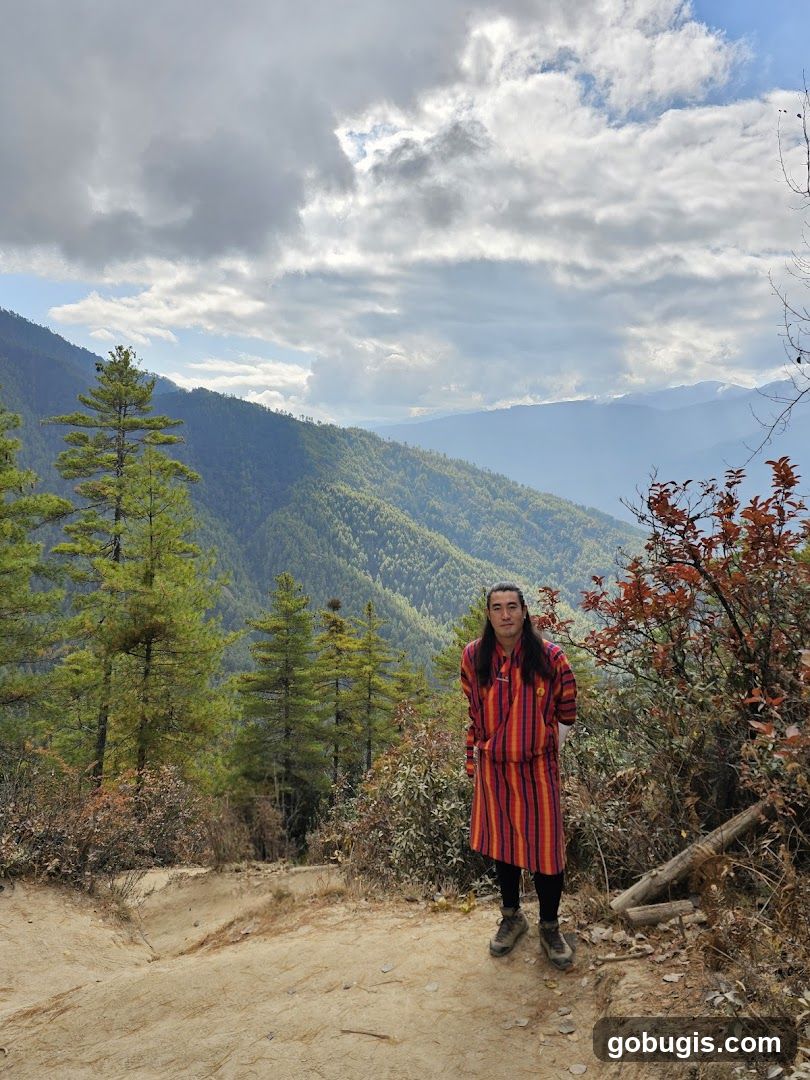 Man in Traditional Bhutanese Attire in a Mountainous Landscape