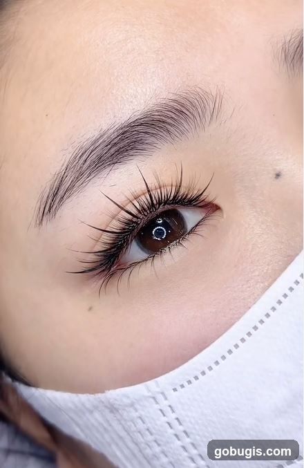 Close-up of a woman's eye with dramatic eyelash extensions