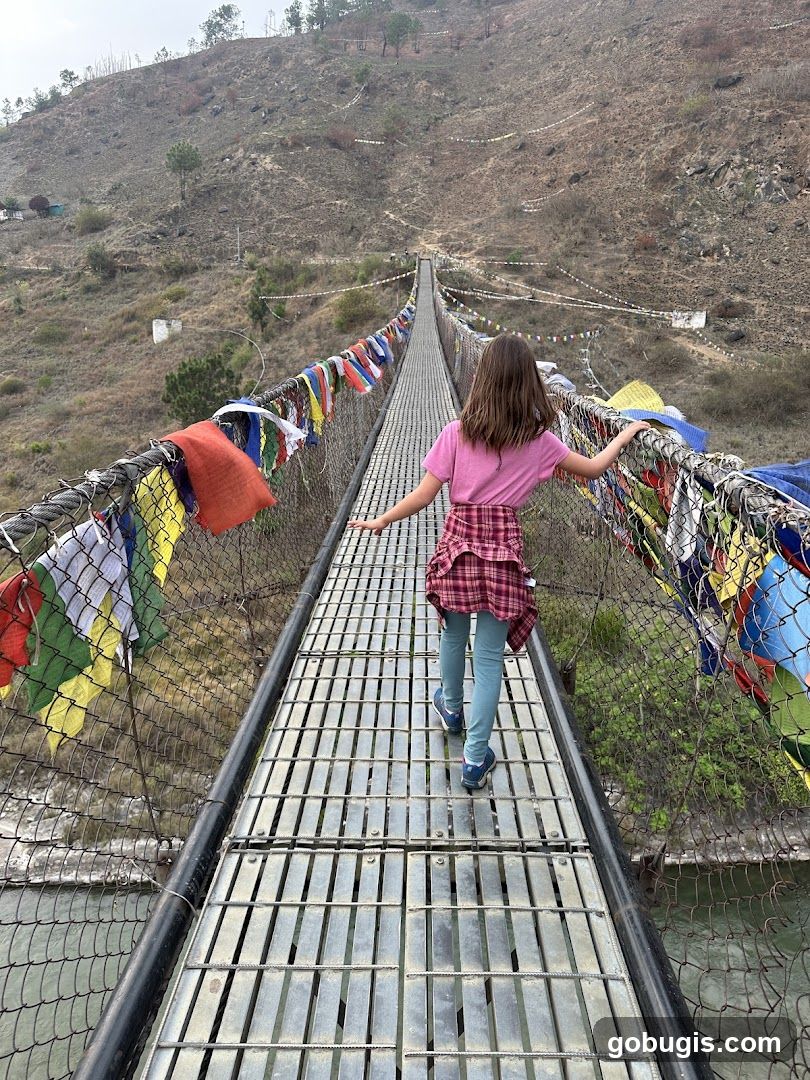 Girl Walking on a Suspension Bridge with Prayer Flags