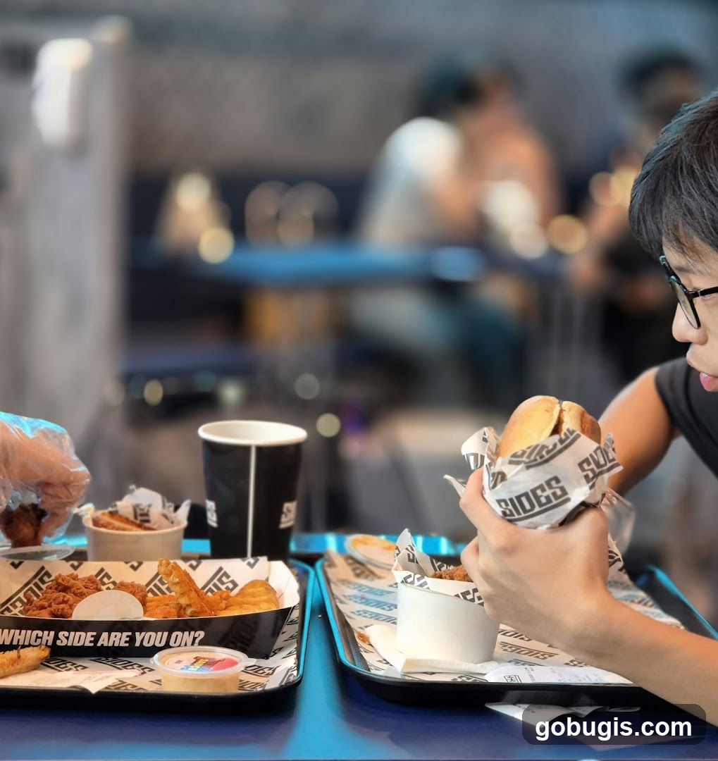 People Eating Burgers and Sides